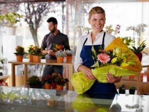 Young woman and client in flowers shop